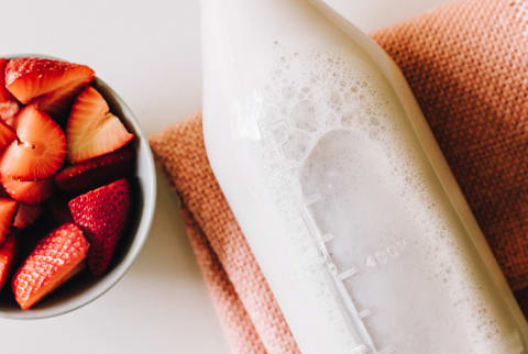 A Bottle of Kefir and a Bowl of Fresh Strawberries A Bottle of Kefir and a Bowl of Fresh Strawberries